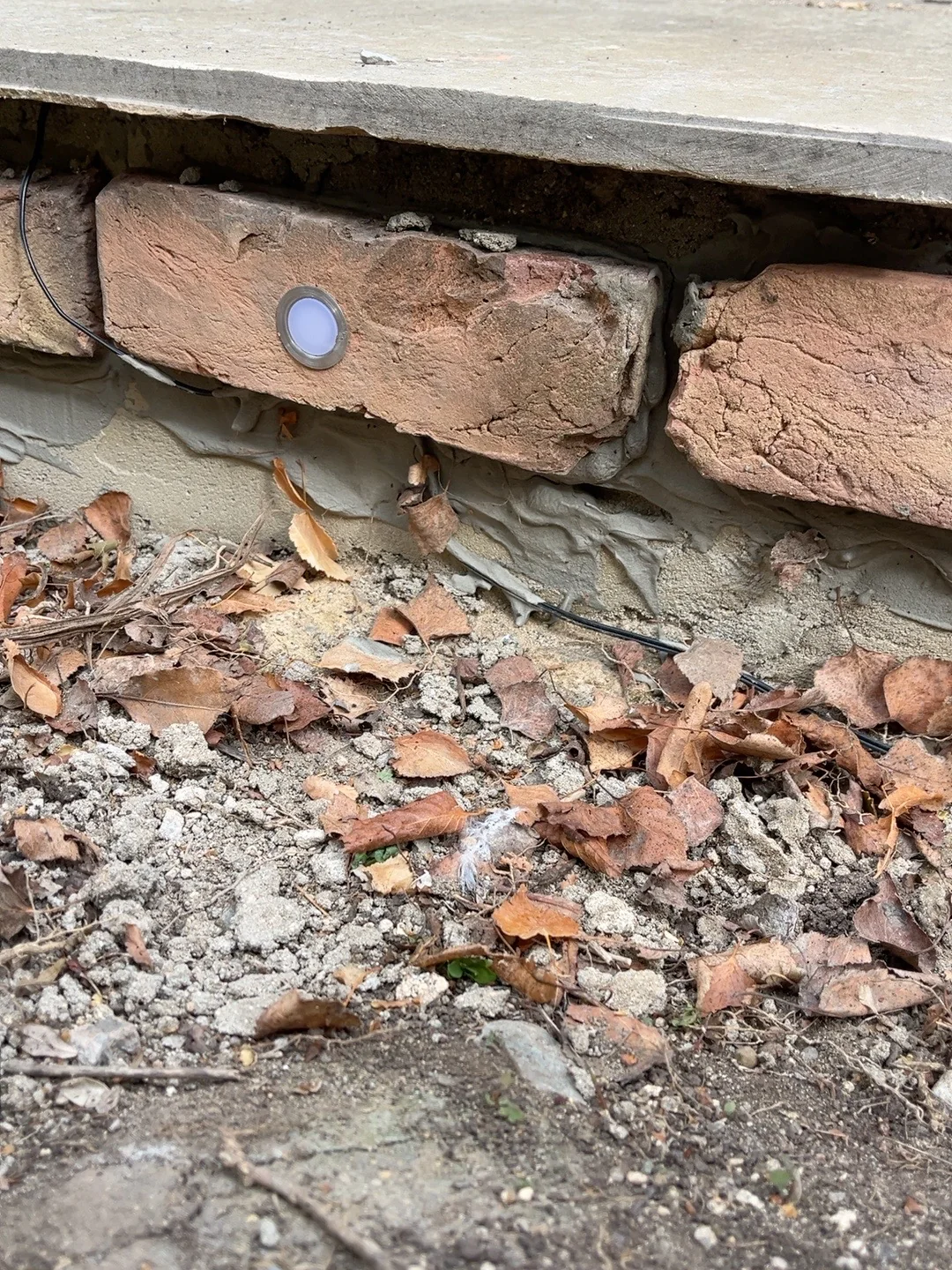 Close-up of a recessed LED in the brick slips during installation