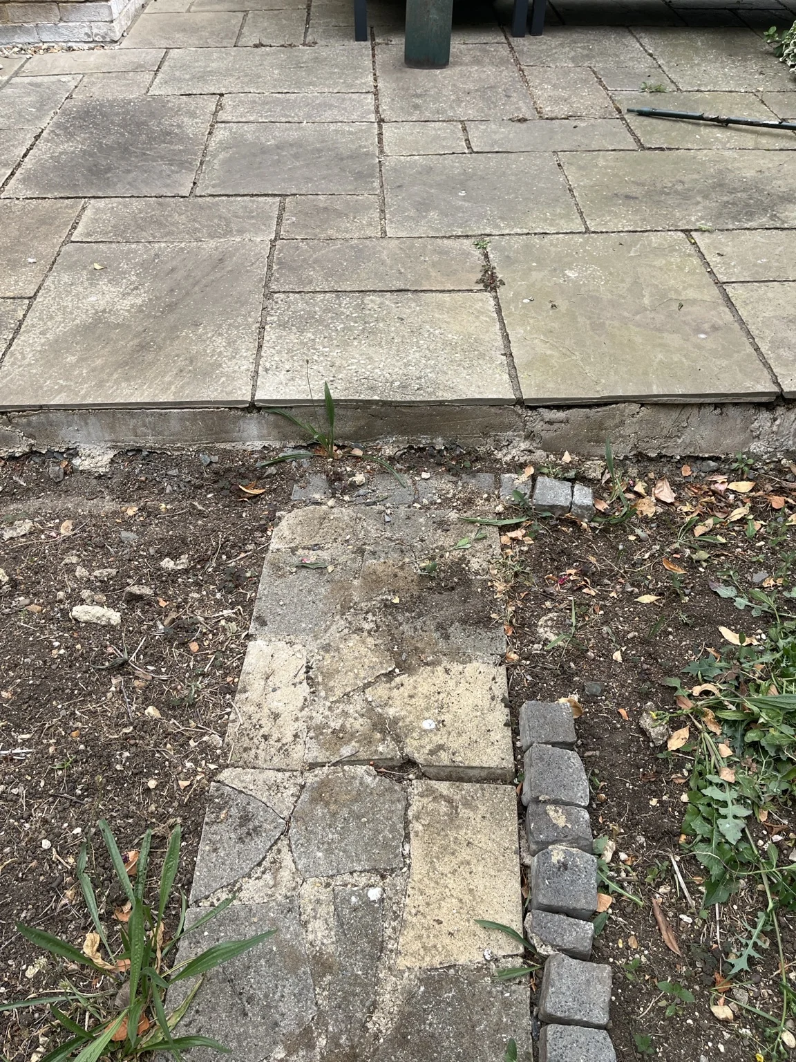 Original concrete retaining wall and patio before the concrete was cut back